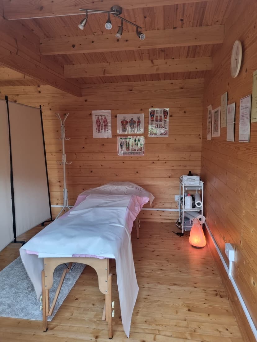 Lena's treatment room, a cosy wooden cabin with massage table and salt lamp